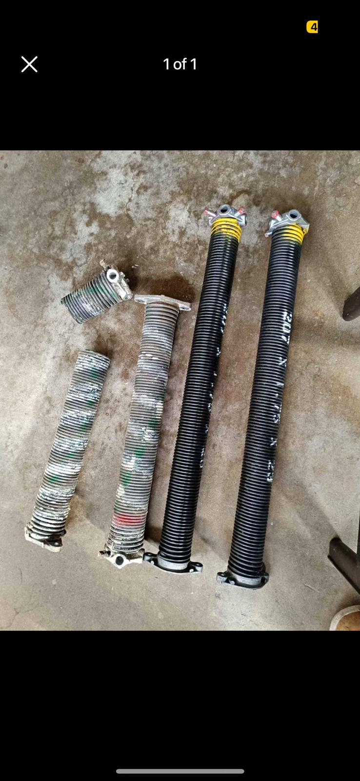 Old broken torsion springs removed from the door