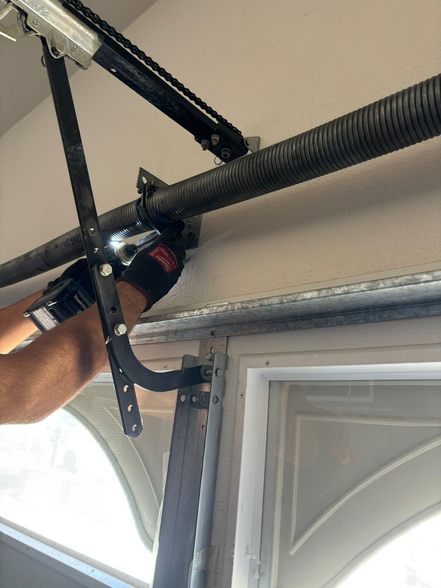 Technician winding a new torsion spring