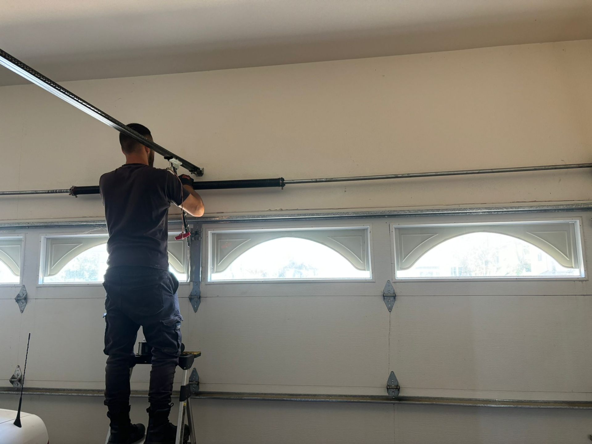 CoilPro technician replacing a torsion spring