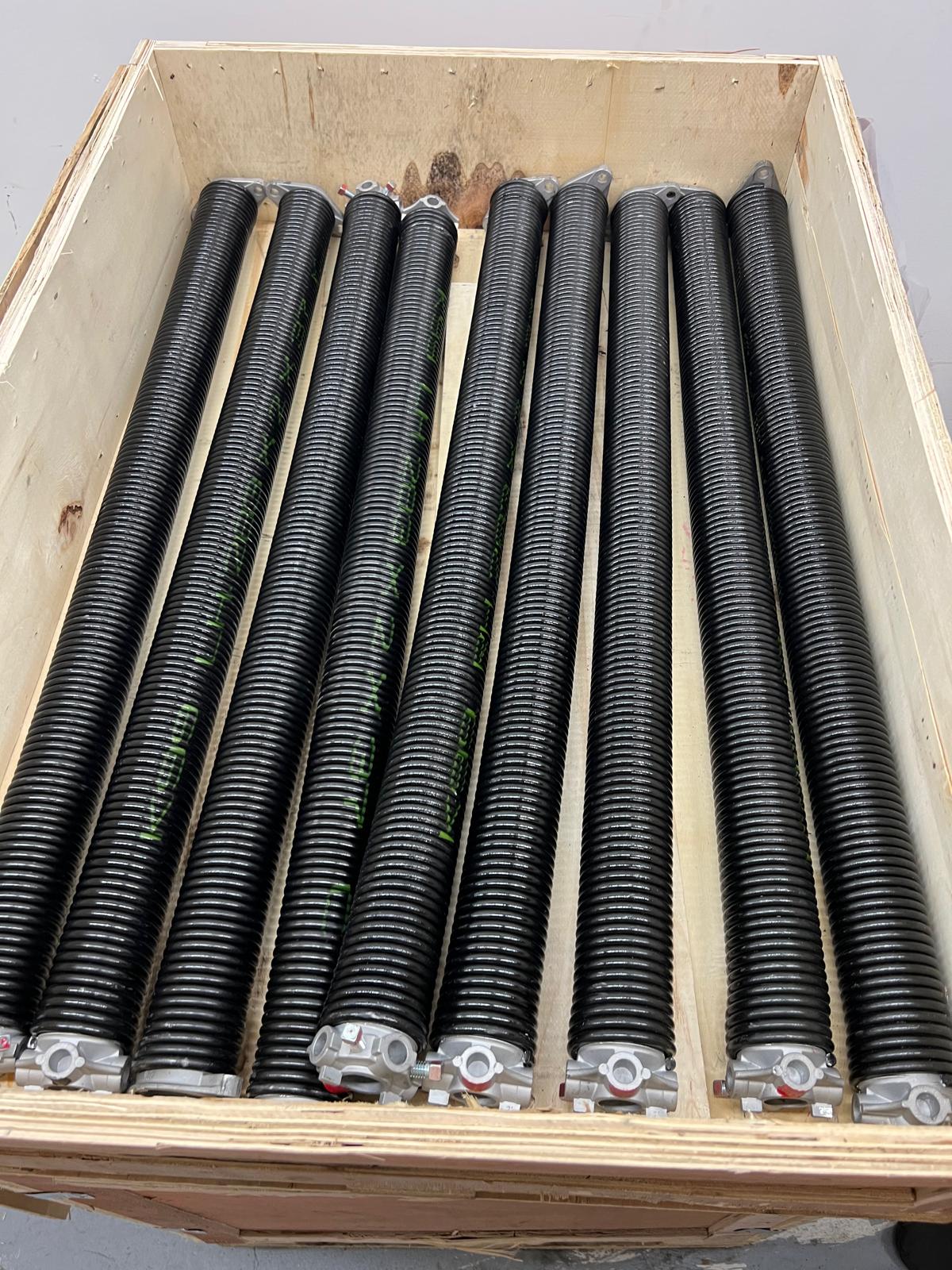 Crate of new high-cycle torsion springs in stock